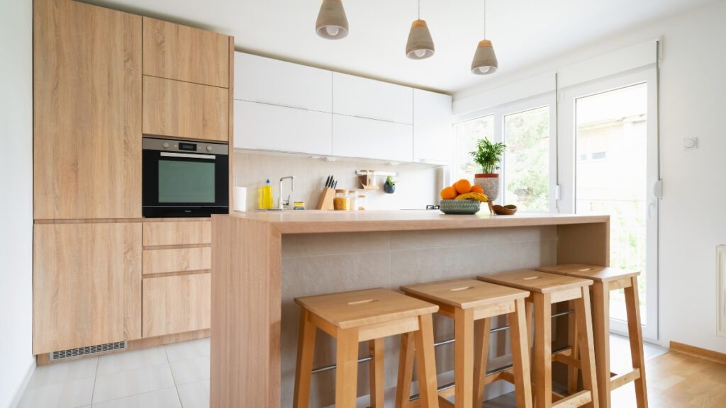 Maid service maintaining a spotless kitchen with polished countertops and sanitized dining surfaces.