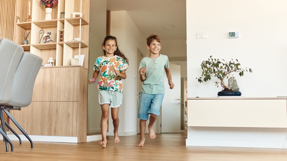 Children playing happily in a tidy home after professional deep cleaning service.